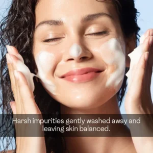 Smiling woman applying gentle lather of a good soap for sensitive skin to wash away impurities leaving skin balanced