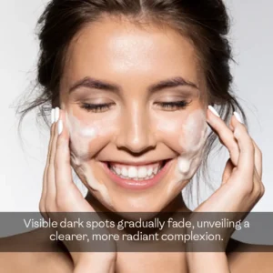 Woman gently washing face with foaming face wash to fade dark spots and achieve a clearer radiant complexion